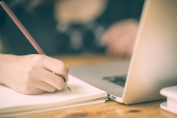 Close up of female designer hands at workplace drawing something with pencil. Project concept